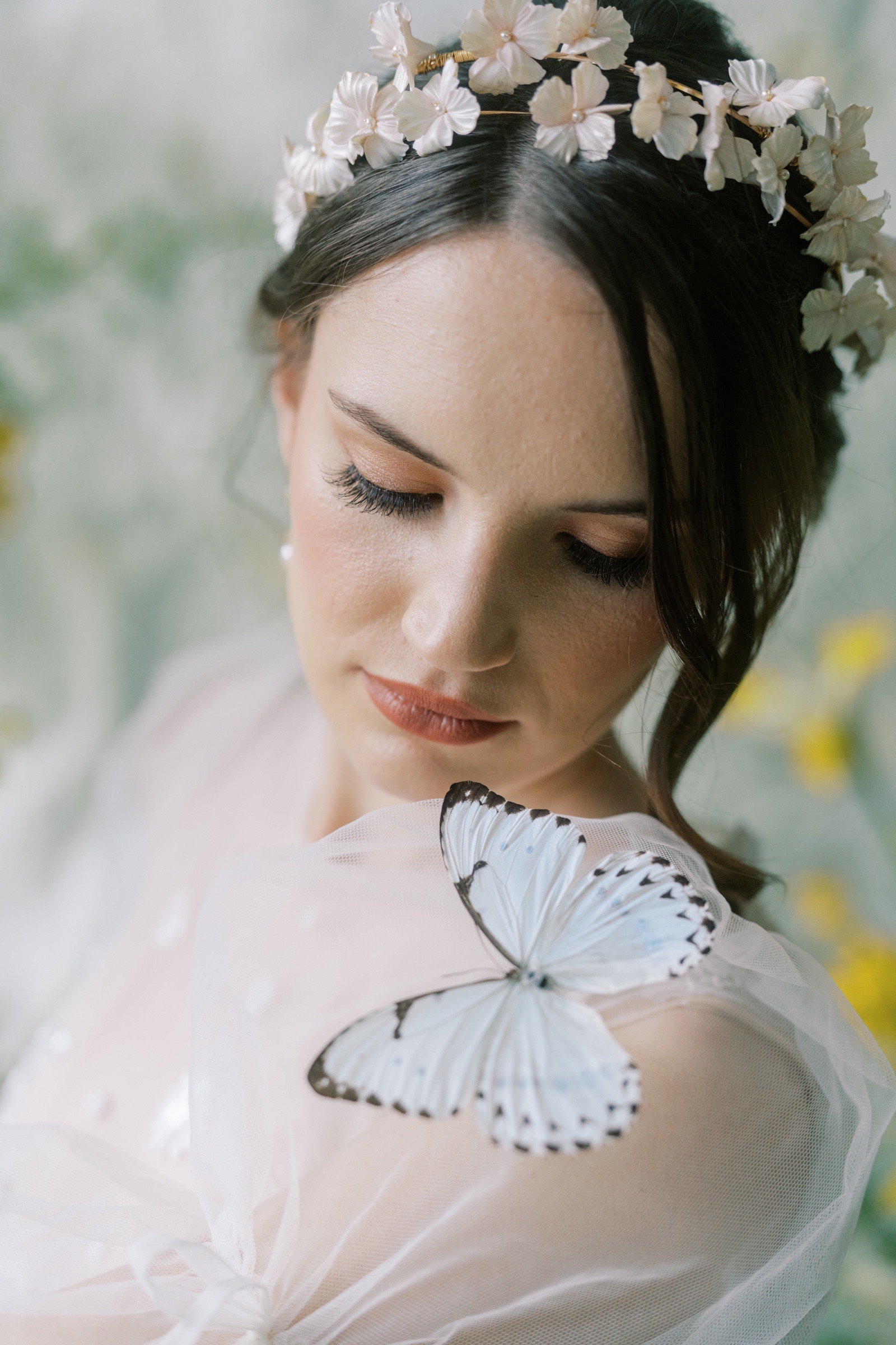 butterfly sitting on brides shoulder with erin rhyne crown 